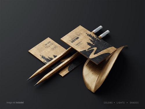 PSD wooden business card mockup scene with pencils and fancy leaf